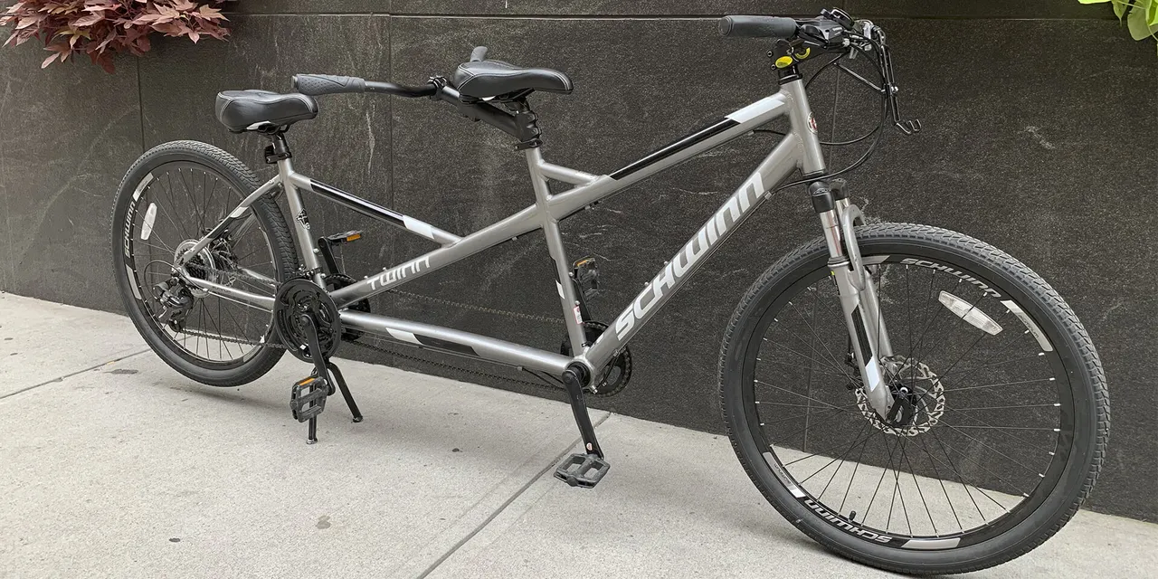 Black electric two-seat tandem with a visible rear battery