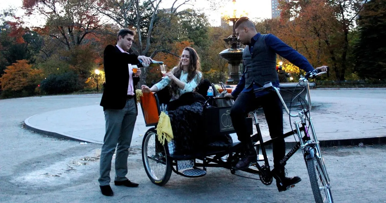 Pedicab guide gesturing at Central Park sights with guests aboard