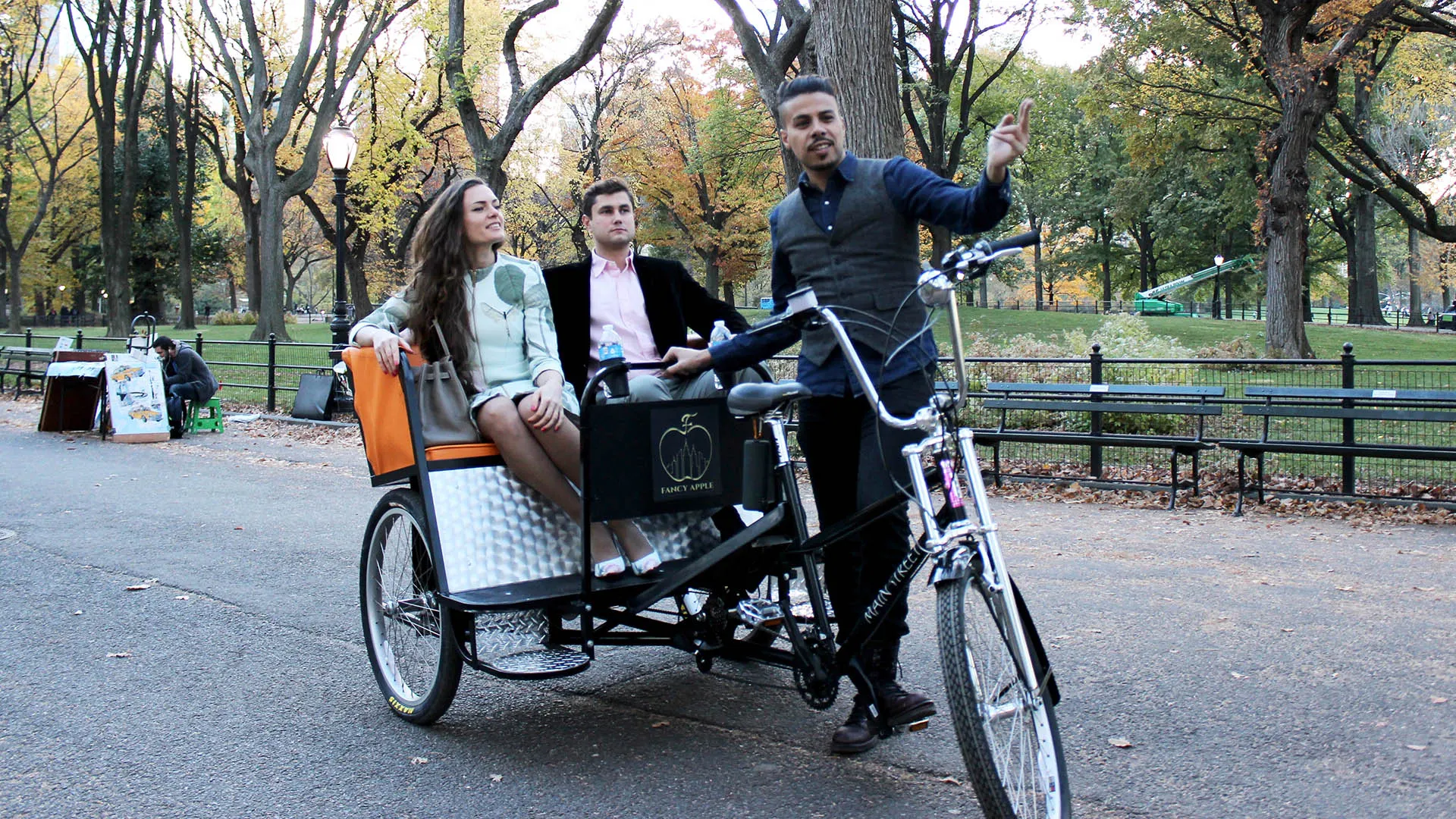Pedicab with guests rolling under the trees in Central Park