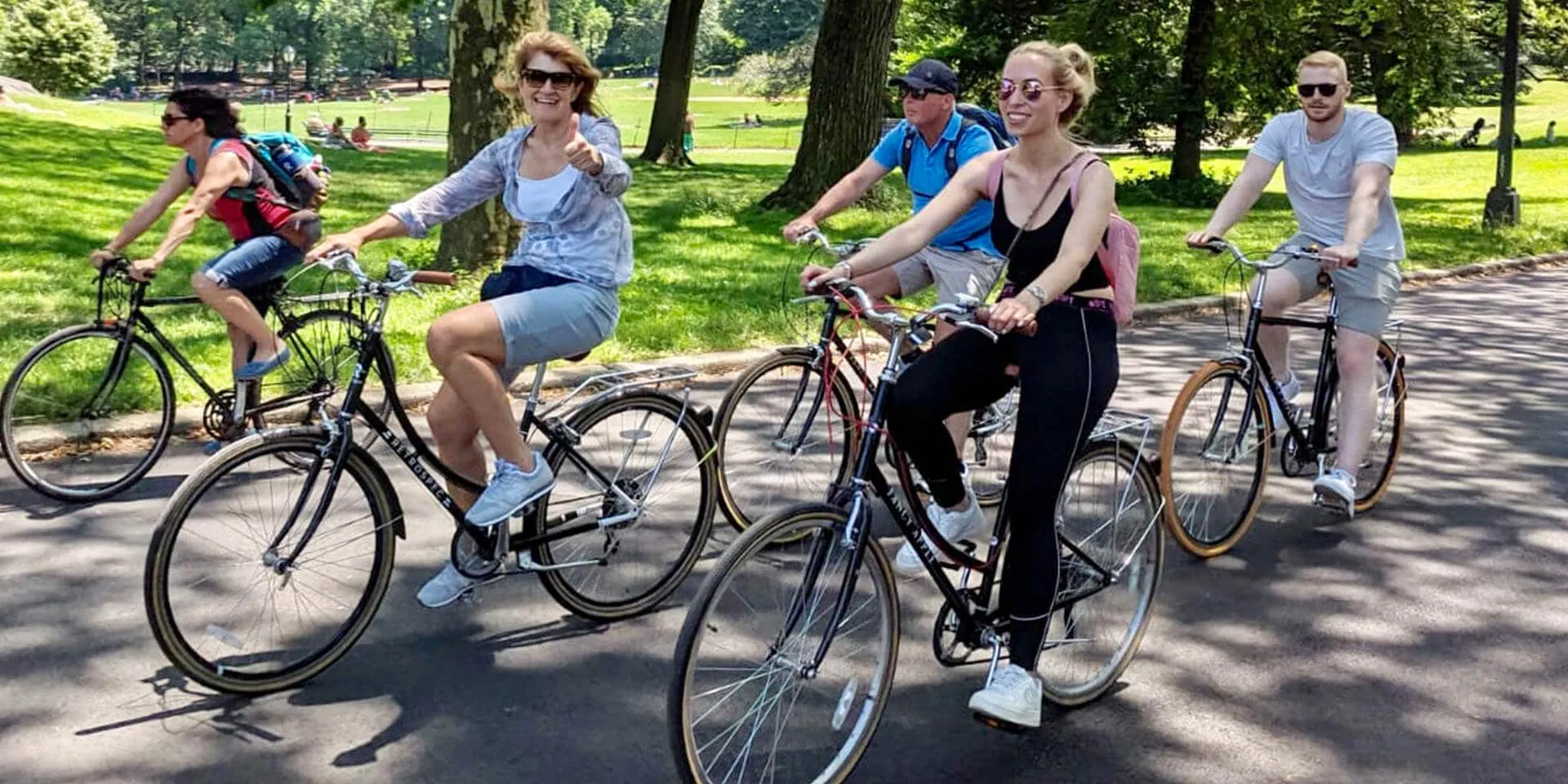 Riders cruising a Central Park drive on rental bikes