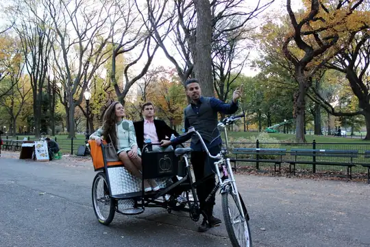 Guide with guests on a pedicab ride in Central Park